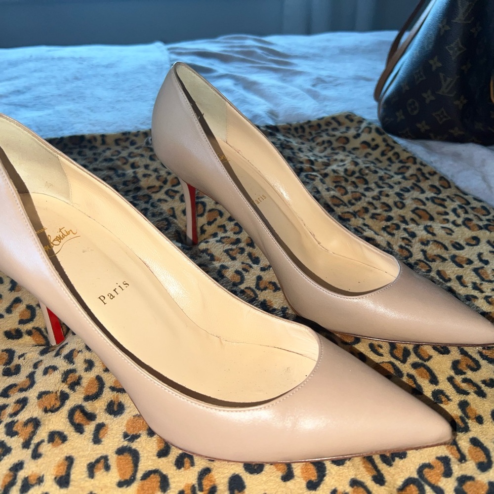 Christian Louboutin Sporty Kate 85 mm pumps in nude or "leche" nappa leather.